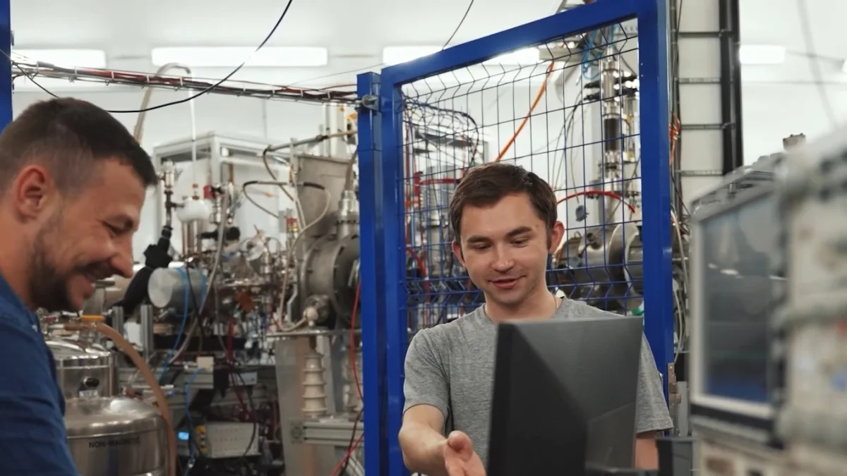 Engineers reviewing an assembled industrial test rig