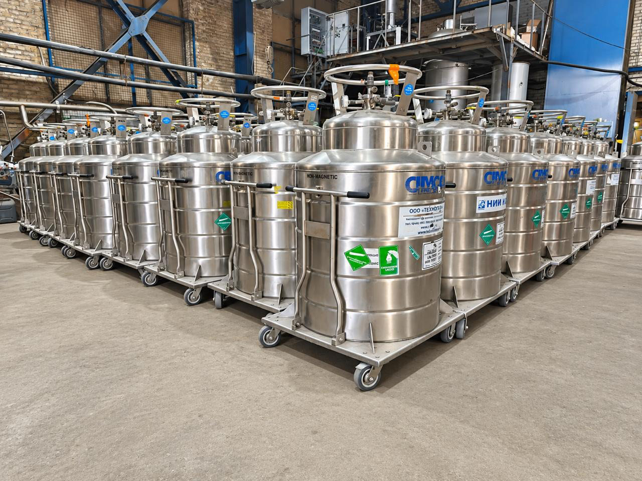 Rows of stainless steel cryogenic Dewars in an industrial facility