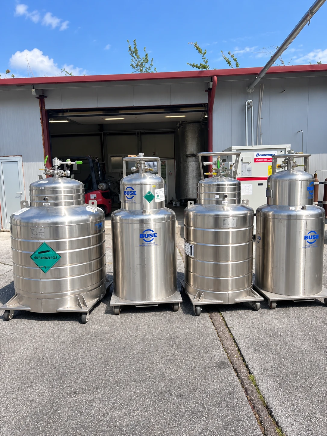Four stainless-steel cryogenic Dewar vessels in different sizes