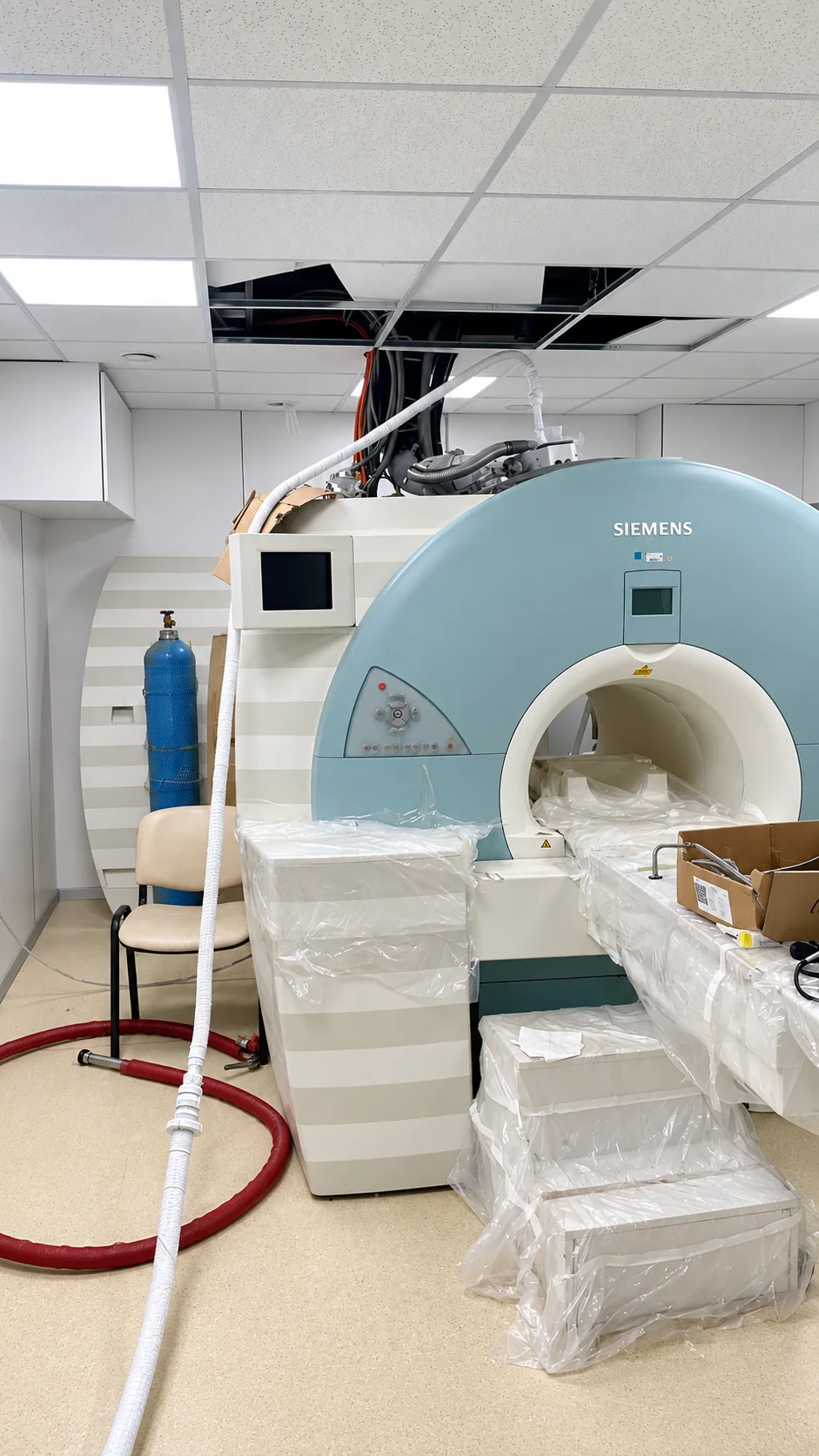 MRI room prepared for service access with a routed cryogenic transfer line