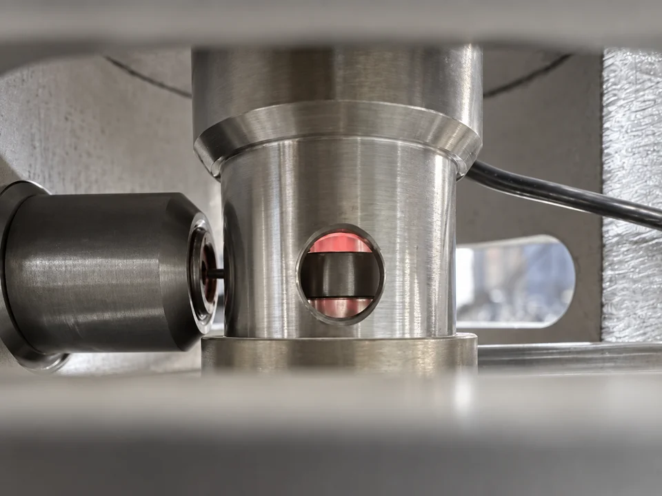 AI-retouched close-up of metal components visible through an analytical instrument housing